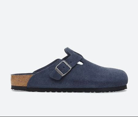 Blue suede clog shoe with a brown sole on a white background